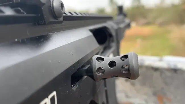 Close-up of the muzzle brake on a black semi-automatic rifle