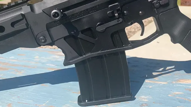 Close-up of the lower receiver of an Armscor VR80 semi-automatic shotgun with a magazine inserted