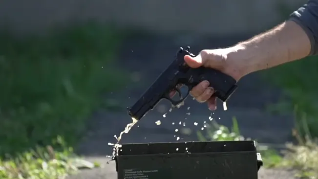 Taking out CZ 75 B out of Ammo box filled with water.