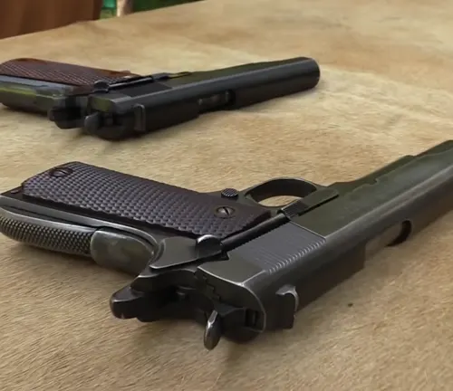 Two Colt 1911 pistols with brown grips