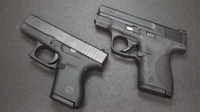 Glock 43 and S&W Shield 9mm pistols side by side for comparison.