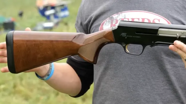 Person holding a Browning A5 Hunter shotgun with wooden stock and forearm