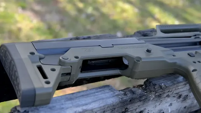 Detailed view of the olive drab Kel-Tec KS7 shotgun's ejection port and stock