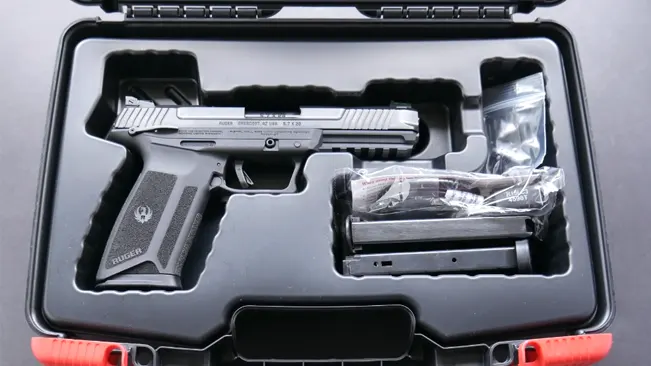 A Ruger 5.7 pistol with two magazines and a lock, neatly arranged in a custom-cut foam insert within a black hardshell case.