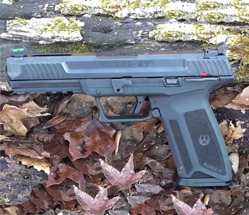 A Ruger 5.7 semi-automatic pistol displayed on a natural background of mossy wood and fallen leaves, featuring green fiber optic sights and a safety indicator.