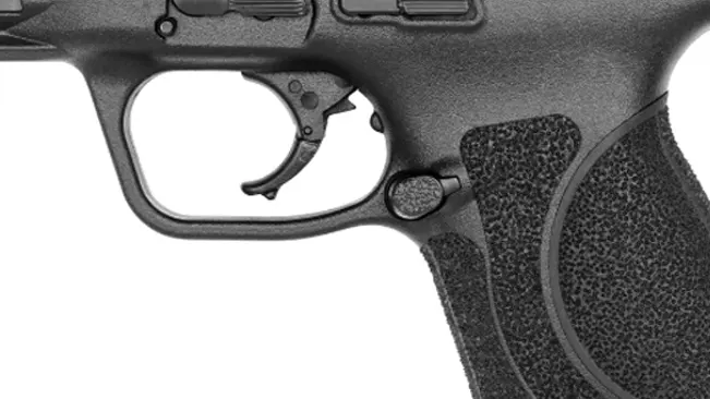 Close-up of S&W M&P 2.0 Compact pistol trigger and textured grip.