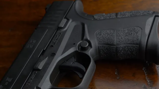 Close-up of a Springfield XD-S pistol grip and trigger