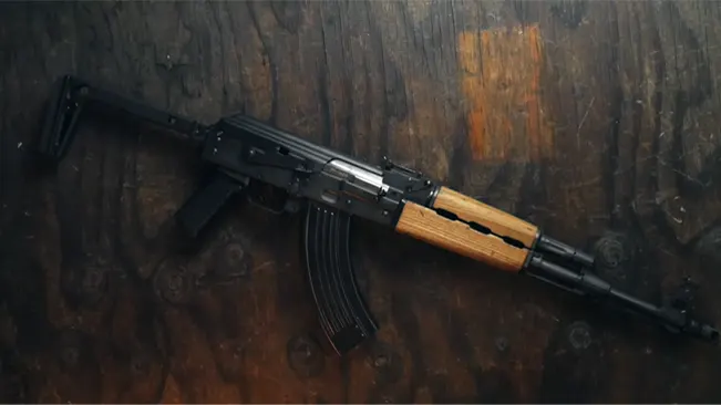 Zastava M70 ZPAP rifle with wooden accents on a dark wooden background.