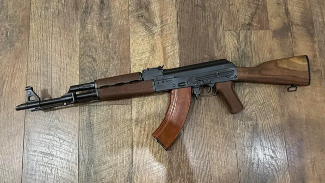 Zastava M70 ZPAP rifle with wood stock on a wooden floor.