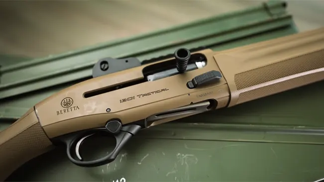 Close-up of a Beretta 1301 Tactical shotgun with a tan stock and receiver
