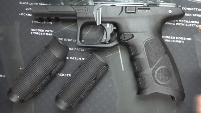 Disassembled Beretta APX with labeled parts and two additional grip backstraps.