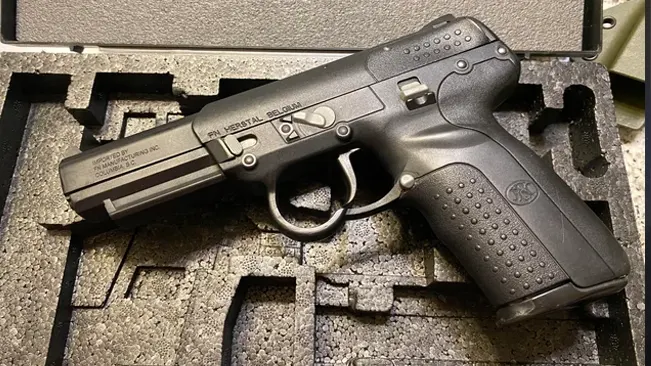 FN Five-SeveN pistol resting in a foam-lined case."