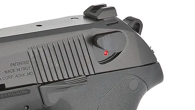 Close-up of a Beretta PX4 Storm subcompact slide, showing the safety switch and red ready-to-fire indicator.