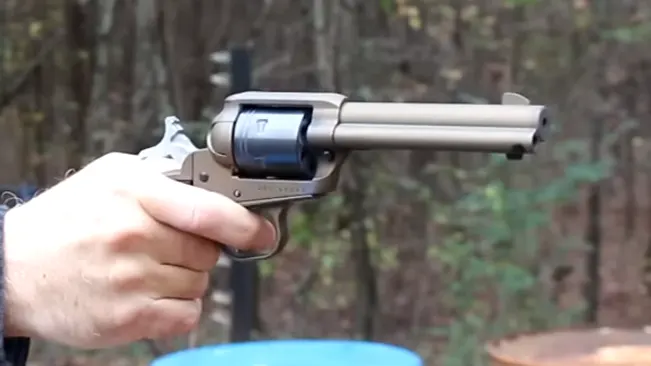 Person holding a Ruger Wrangler 22LR revolver, ready to fire.