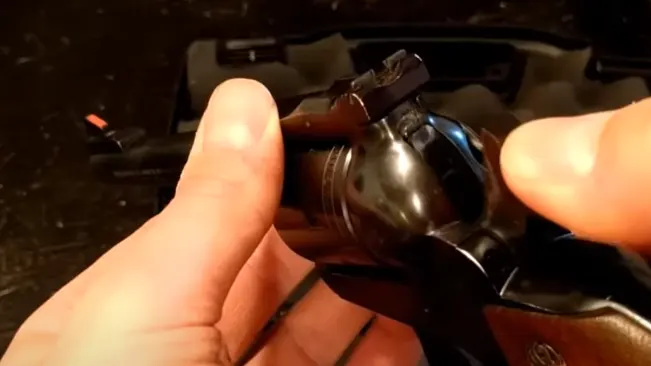 Hand cocking the hammer of a Ruger Single-Six revolver.