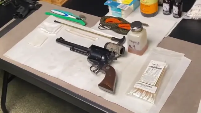 Ruger Super Blackhawk .44 revolver with cleaning supplies on a table.