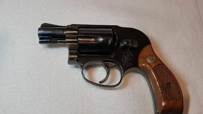 S&W Model 49 Bodyguard revolver with wooden handle on a white background.
