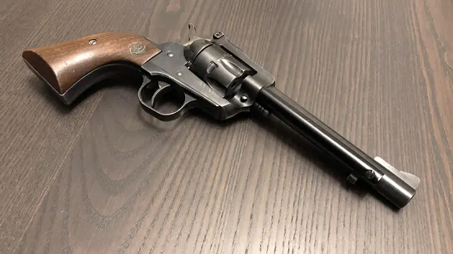 Ruger Single-Six revolver on a wood grain surface.