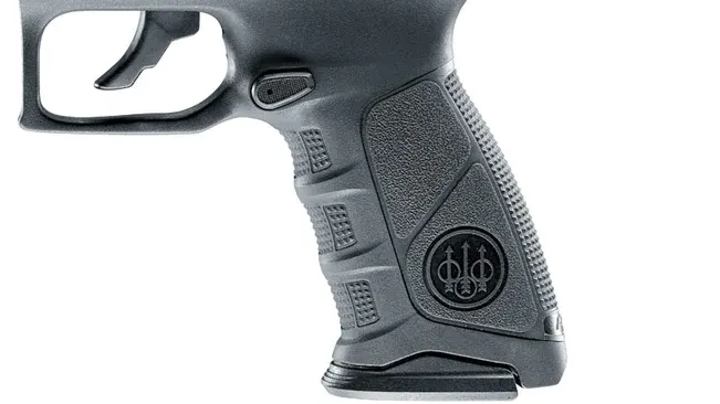 Close-up of a Beretta APX pistol grip with textured panels and logo.