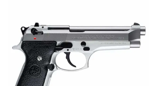 Beretta 92FS INOX with stainless steel finish and black grips, showing the safety engaged and red dot indicator.