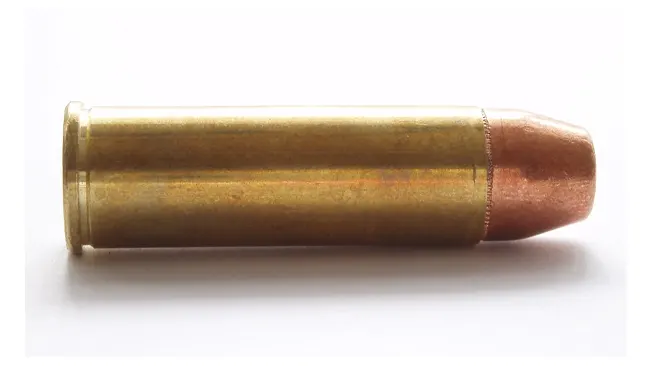 A .454 Casull cartridge with a brass casing and copper bullet, commonly used in the Freedom Arms Model 83 revolver.
