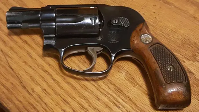 S&W Model 49 Bodyguard revolver on a wooden surface.