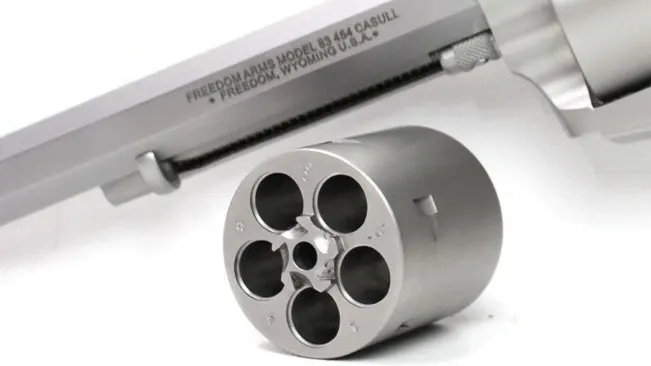 Close-up of the cylinder and barrel of a Freedom Arms Model 83 revolver chambered in .454 Casull, with engraving detail.
