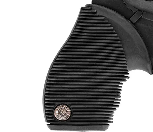 Close-up of the ribbed grip and emblem on a Taurus Judge Public Defender 2 revolver.