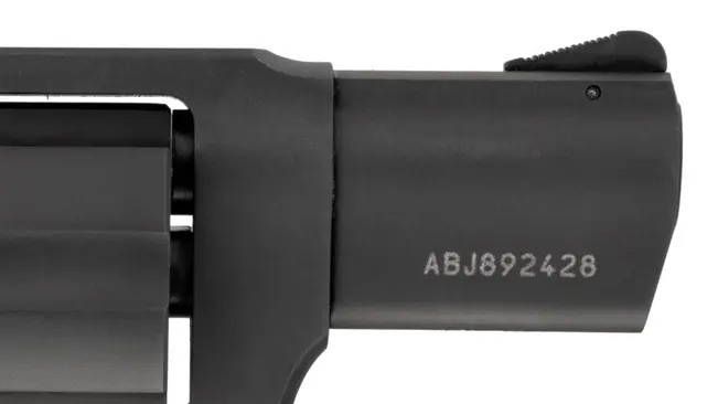 Close-up of the barrel and frame of a Taurus 856 revolver with serial number ABJ892428 on a white background.