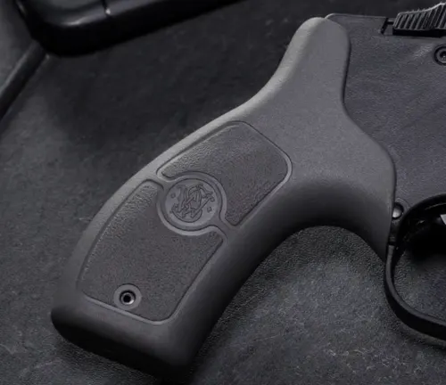 Close-up of the polymer grip with the Smith & Wesson logo on an M&P Bodyguard 38 revolver.