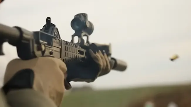 close-up of a person firing a Kel-Tec SUB-2000 rifle