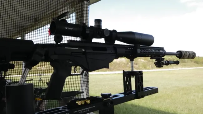 Ruger Precision Rifle mounted on a shooting rest at an outdoor range with a scope attached