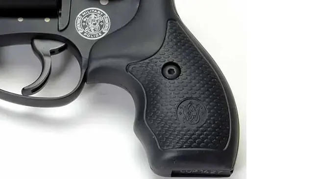 Detail of the grip and emblem on a Smith & Wesson J-Frame 340 PD revolver's handle.