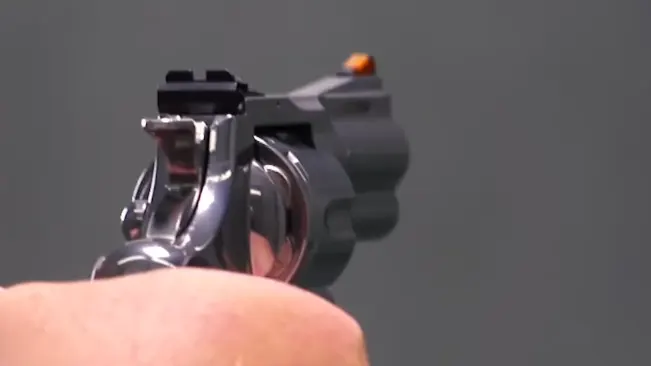 Rear view of a Colt Python 3-inch revolver being aimed, showing the sight alignment.