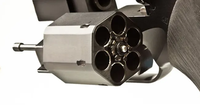 Close-up of the open cylinder of a Chiappa Rhino revolver, showing empty chambers.