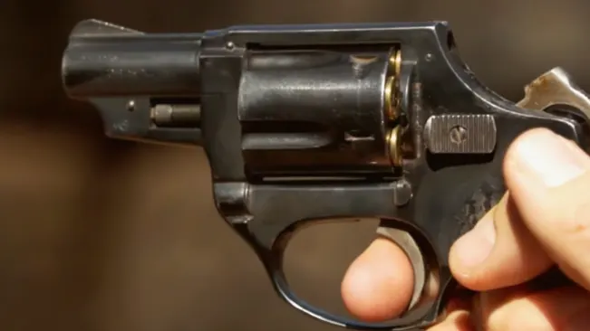 Hand loading bullets into the cylinder of an Astra 680 revolver.