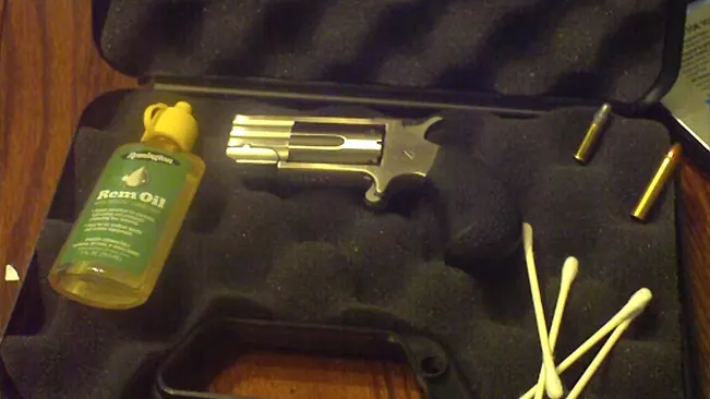 North American Arms Pug .22 revolver in a case with gun oil and cleaning supplies.