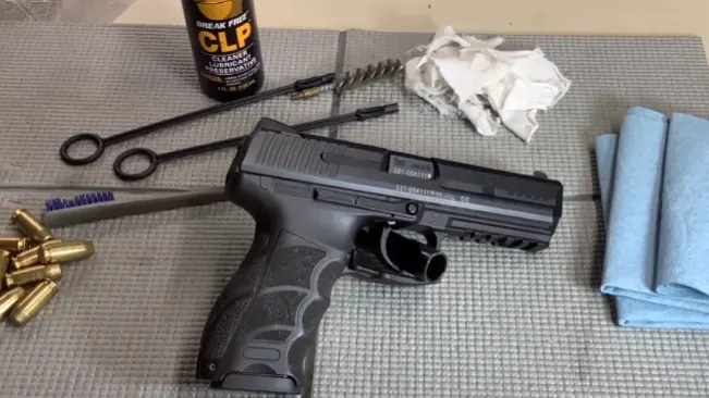 HK P30L handgun laid out on a mat with cleaning tools