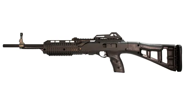 Black tactical rifle with extended barrel, rail system, and cut-out buttstock.