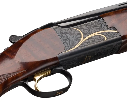 Close-up view of an engraved double-barrel shotgun showing detailed scrollwork on the receiver with a wooden stock and forend.