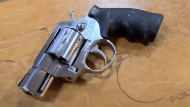 Rock Island Armory AL3.1 revolver with a shiny metal finish on a wooden surface.