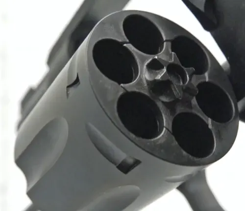 Close-up of the cylinder of a Colt Night Cobra revolver showing empty chambers.