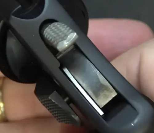 Close-up of the hammer and rear sight on a Smith & Wesson Model 351 PD revolver held in a hand.