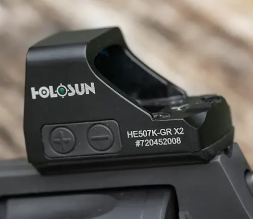 Close-up of a Holosun HE507K-GR X2 red dot sight mounted on a firearm.
