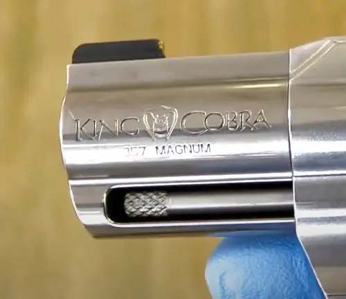 Close-up of the barrel of a King Cobra Carry .357 Magnum revolver, showing the engraved name and caliber.