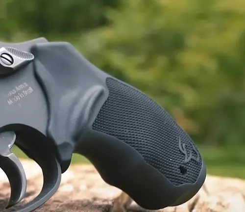 Close-up of the textured grip on a Taurus 856 TORO revolver with a natural backdrop.