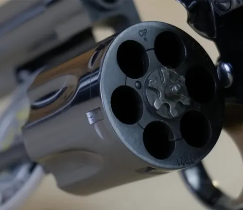 Close-up view of the open cylinder of a Manurhin MR73 revolver, showcasing empty chambers.