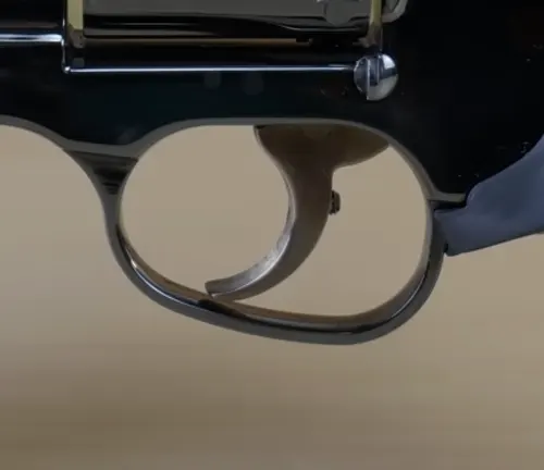Close-up of the trigger and trigger guard on a Manurhin MR73 revolver.