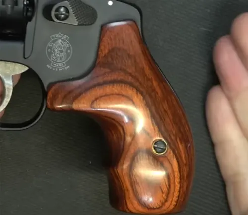 Close-up of the wooden grip on a Smith & Wesson Model 351 PD revolver.