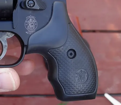 Close-up of the synthetic grip on a Smith & Wesson Model 43C revolver held in a hand.